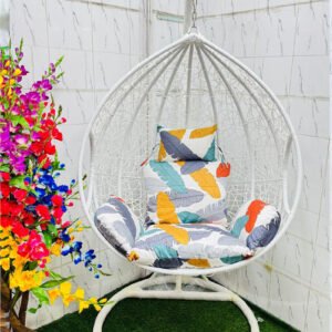 Premium white hanging egg swing chair with heavy-duty metal stand, colorful leaf-pattern cushions, PE rattan basket, 180 kg weight capacity, ideal for indoor and outdoor use.