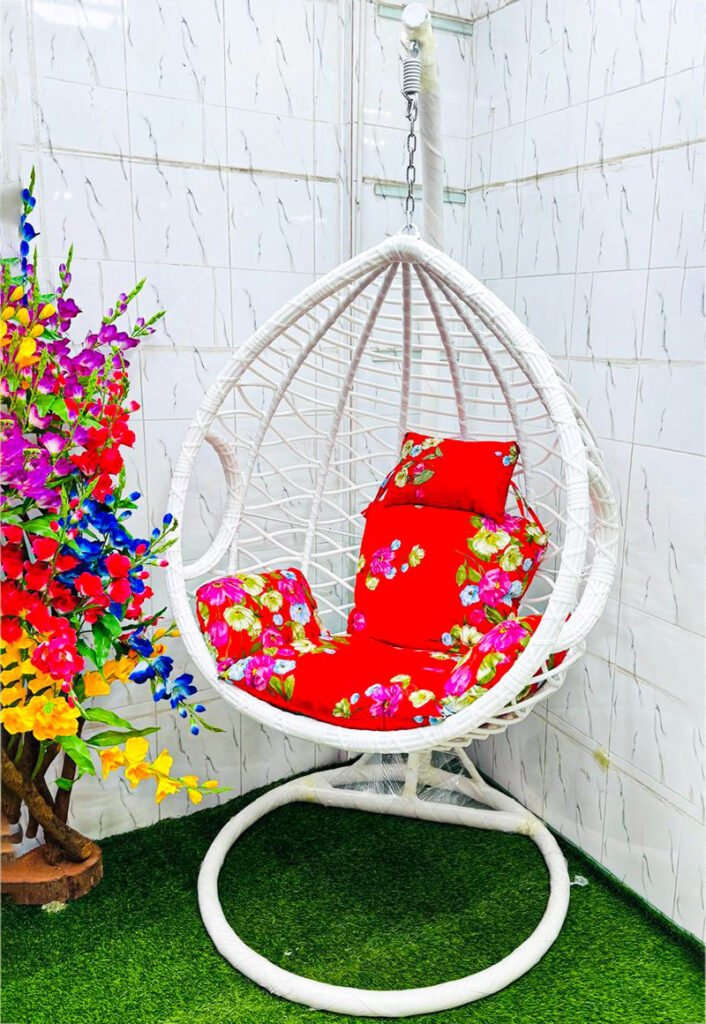 Premium white hanging egg swing chair with luxury red floral cushions, heavy-duty metal stand, PE rattan basket, 180 kg weight capacity, ideal for indoor and outdoor use in balcony, garden, rooftop and living room.